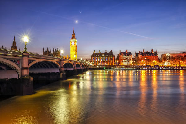 Night view of Palace of Westminster and Big Ben reflecting on Thames river. London United Kingdom Europe