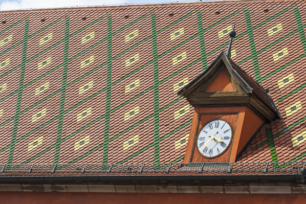Clock on colorful roof Nordlingen Bavaria Southern Germany Europe