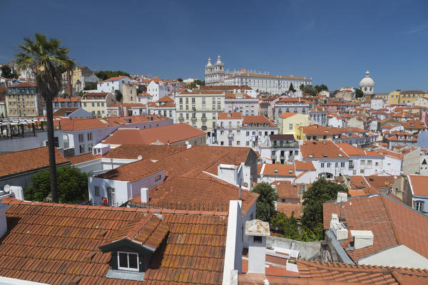 View of terracotta roofs and the ancient castle and dome from Miradouro Alfama viewpoint of Lisbon Portugal Europe