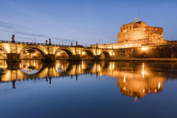 Dusk on the ancient palace of Castel Sant'Angelo with statues of angels on the bridge on Tiber RIver Rome Lazio Italy Europe
