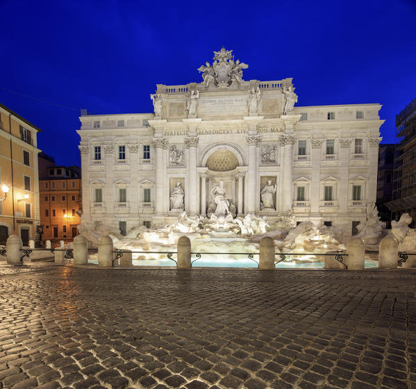 View of Trevi Fountain illuminated by street lamps and the lights of dusk Rome Lazio Italy Europe