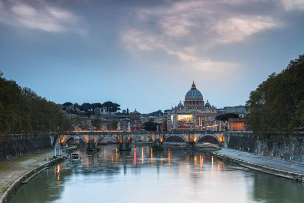 Dusk lights on Tiber River with bridge Umberto I and Basilica di San Pietro in the background Rome Lazio Italy Europe