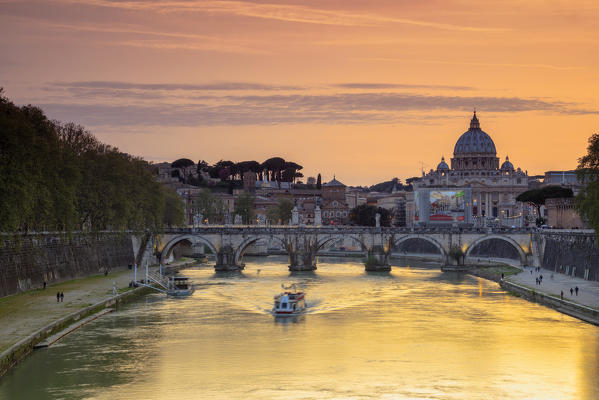 A romantic sunset on Tiber River with bridge Umberto I and Basilica di San Pietro in the background Rome Lazio Italy Europe