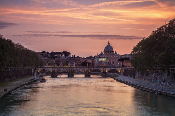 A romantic sunset on Tiber River with bridge Umberto I and Basilica di San Pietro in the background Rome Lazio Italy Europe