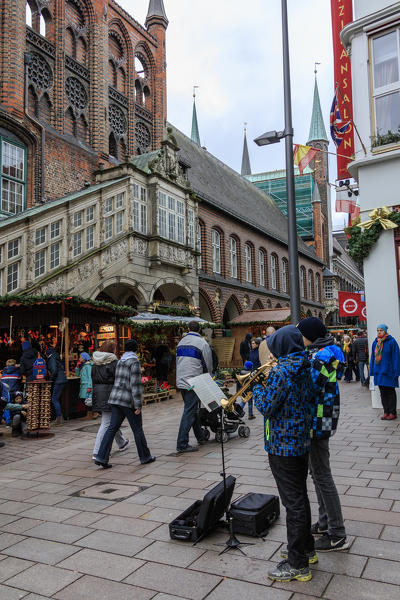 Street musicians and tourists in the old gothic style city center of Lübeck Schleswig Holstein Germany Europe