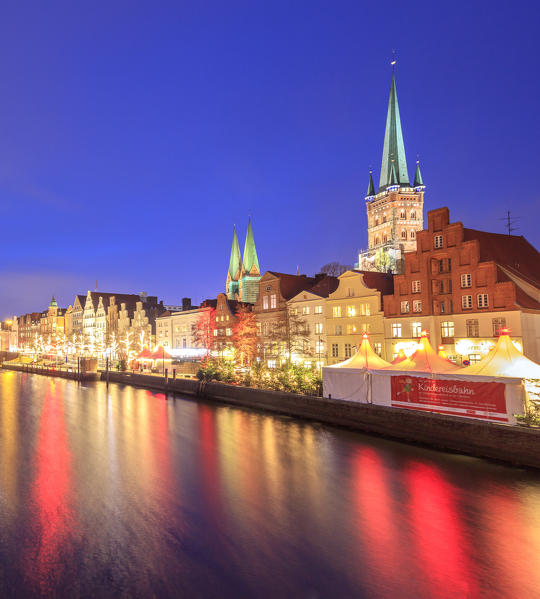Night view of typical houses and the cathedral reflected in river Trave Lübeck Schleswig Holstein Germany Europe