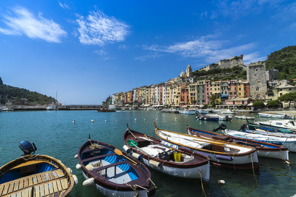 Boats in the blue sea frame the typical colored houses of Portovenere La Spezia province Liguria Italy Europe