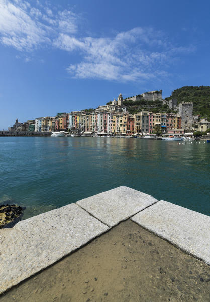 View from the pier of blue sea which frames the typical colored houses of Portovenere La Spezia province Liguria Italy Europe