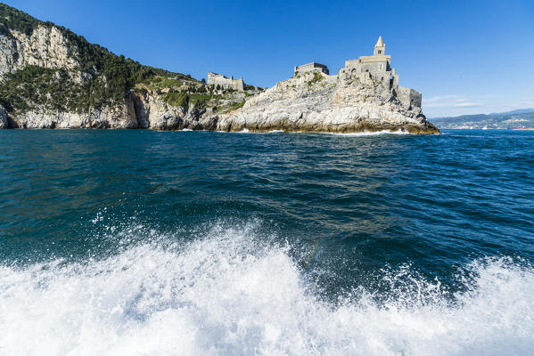 Blue sea frames castle and the ancient church perched on the promontory Portovenere province of La Spezia Liguria Italy Europe