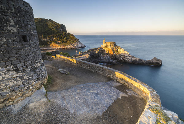 Sunrise on the old castle and church perched on the promontory Portovenere province of La Spezia Liguria Italy Europe