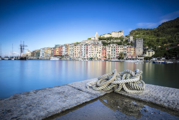 The blue sea at dusk frames the typical colored houses of Portovenere La Spezia province Liguria Italy Europe