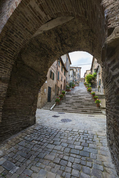A typical alley of the old town in the medieval village of Corinaldo Province of Ancona Marche Italy Europe