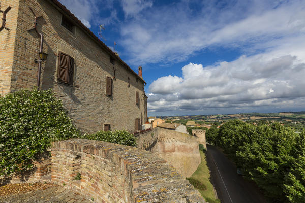 Blue sky frames the typical buildings of the old town surrounded by fields Corinaldo Province of Ancona Marche Italy Europe