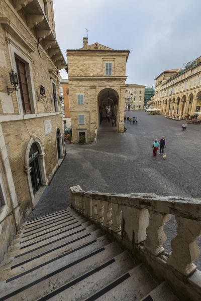 A typical flight of steps among the historical buildings and arcades of Piazza del Popolo Fermo Marche Italy Europe