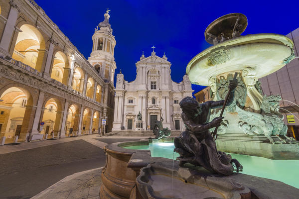 Night view of the Basilica of the Holy House and fountain decorated with statues Loreto Province of Ancona Marche Italy Europe