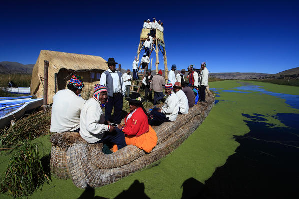 To visitors to Lake Titicaca, a boat trip to the floating islands, a unique tourist destination, is a must. These islands are made and re-made from the totora reeds which provide home, sustenance and transportation for their residents Peru South America