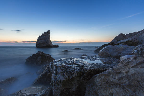 Blue light at dusk on cliffs framed by clear sea La Vela Beach Portonovo province of Ancona Conero Riviera Marche Italy Europe