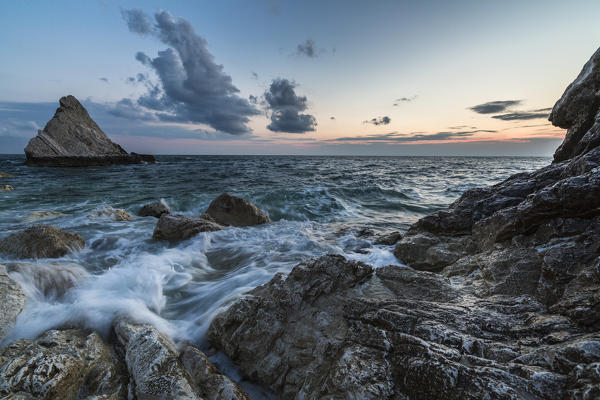 Waves of blue sea framed by the pink sunrise La Vela Beach Portonovo province of Ancona Conero Riviera Marche Italy Europe