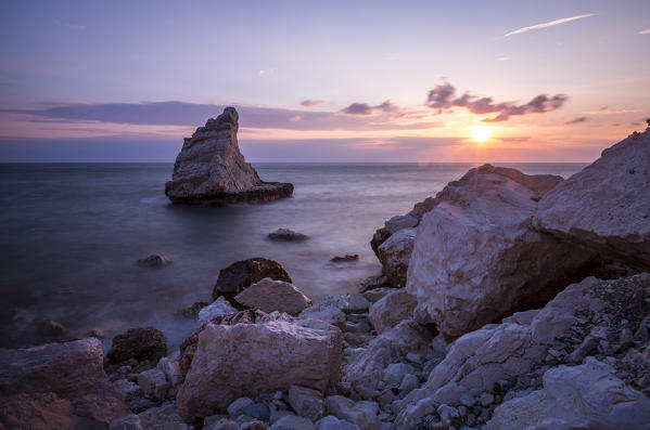 Cliffs and sea framed by the pink sky at sunrise La Vela Beach Portonovo province of Ancona Conero Riviera Marche Italy Europe