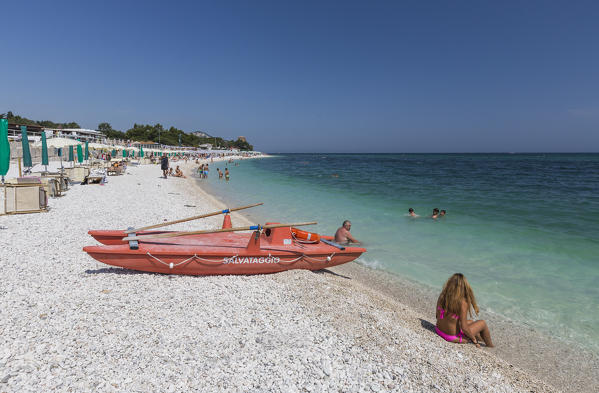 Tourists on the beach framed by the turquoise sea province of Ancona Conero Riviera Marche Italy Europe