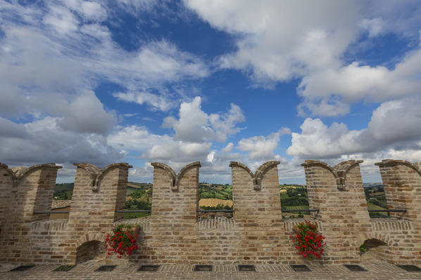 Blue sky and clouds frame the typical architecture of the old town of Corinaldo Province of Ancona Marche Italy Europe