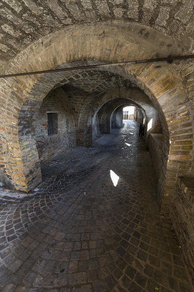 A typical alley and medieval walls of the old town of Corinaldo Province of Ancona Marche Italy Europe