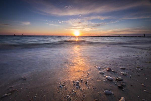 The lights of dawn are reflected on the sandy beach Porto Recanati Province of Macerata Conero Riviera Marche Italy Europe