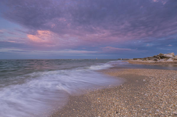 Pink sky is reflected in the clear water at sunset Porto Recanati Province of Macerata Conero Riviera Marche Italy Europe