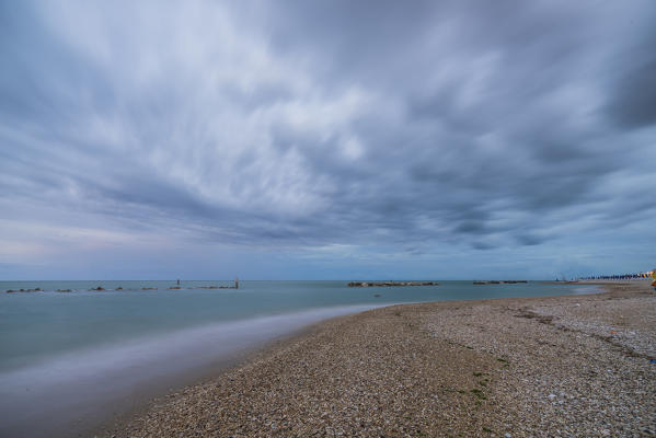 Storm clouds are reflected in the clear water at dusk Porto Recanati Province of Macerata Conero Riviera Marche Italy Europe
