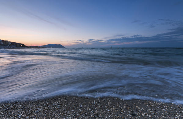 Waves crashing on the beach framed by the blue dusk Porto Recanati Province of Macerata Conero Riviera Marche Italy Europe