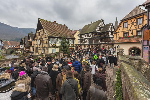 Tourists on a bridge in the medieval town overlooking river Weiss Kaysersberg Haut-Rhin department Alsace France Europe