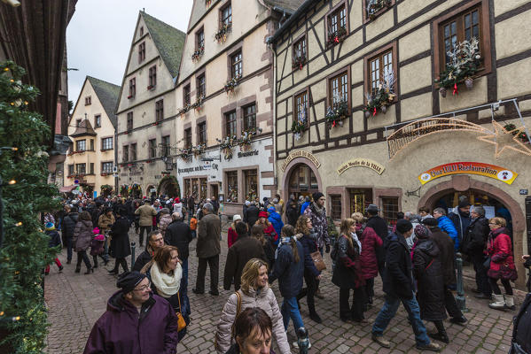 Tourists in the pedestrian road of the old town at Christmas time Kaysersberg Haut-Rhin department Alsace France Europe