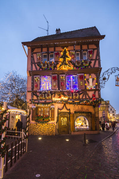 A typical house enriched by Christmas ornaments and lights at dusk Colmar Haut-Rhin department Alsace France Europe