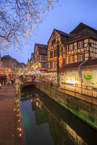 Tourists shopping at the Christmas Markets in the old medieval town of Colmar Haut-Rhin department Alsace France Europe