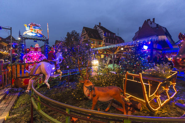 Christmas lights and typical carousel in the old medieval town Colmar Haut-Rhin department Alsace France Europe