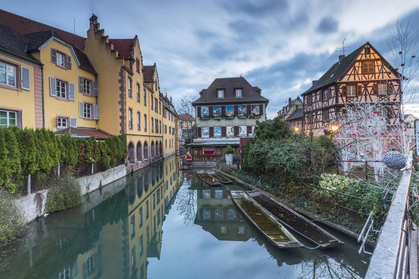 Dusk lights on houses reflected in river Lauch at Christmas Petite Venise Colmar Haut-Rhin department Alsace France Europe