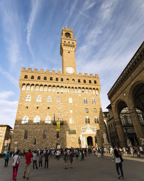 Tourists admire the facade of Palazzo Vecchio from Piazza Della Signoria Florence Tuscany Italy Europe