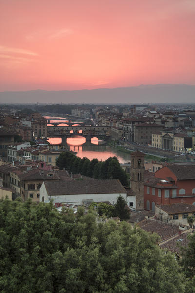 Pink sunset on the Arno River and Ponte Vecchio seen from Piazzale Michelangelo Florence Tuscany Italy Europe