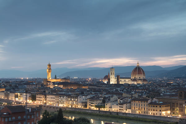 The blue light of dusk frames the city of Florence crossed by Arno River seen from Piazzale Michelangelo Tuscany Italy Europe