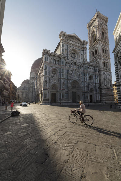 A bicycle frames the ancient Duomo di Firenze and Giotto's Campanile at sunrise Florence Tuscany Italy Europe