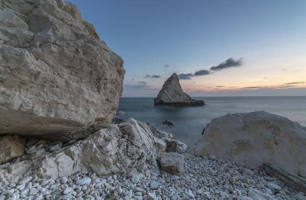 Dusk lights on cliffs framed by clear sea La Vela Beach Portonovo province of Ancona Conero Riviera Marche Italy Europe