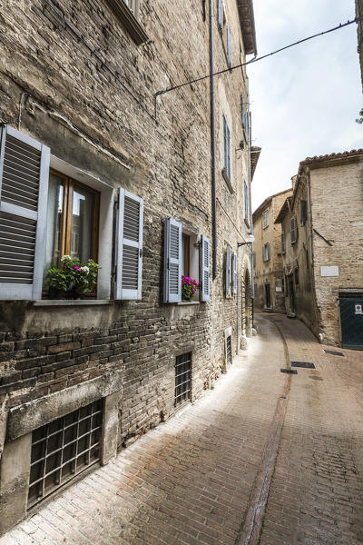 A typical alley of the ancient medieval hill town of Urbino Province of Pesaro Marche Italy Europe