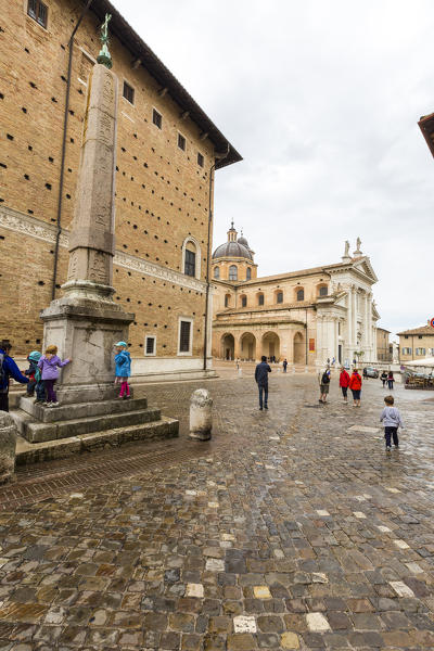 The Egyptian obelisk surrounded by the historical buildings of the old town Urbino Province of Pesaro Marche Italy Europe
