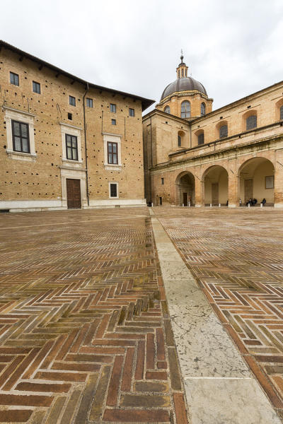 View of the medieval Piazza Rinascimento and arcades beside Palazzo Ducale Urbino Province of Pesaro Marche Italy Europe