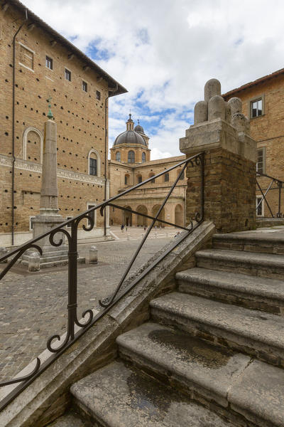 View of the Egyptian obelisk in Piazza Rinascimento opposite the Palazzo Ducale Urbino Province of Pesaro Marche Italy Europe