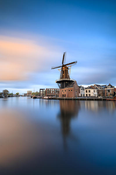 Pink clouds at sunset on the Windmill De Adriaan reflected in river Spaarne Haarlem North Holland The Netherlands Europe