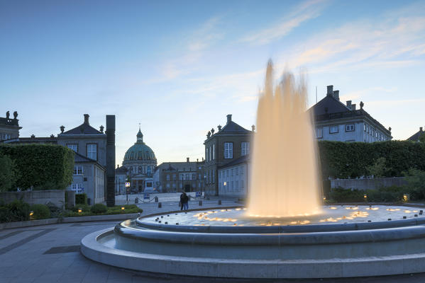 Amalienborg Palace Square and Marble Church seen from the illuminated fountain in Amalie Garden, Copenhagen, Denmark