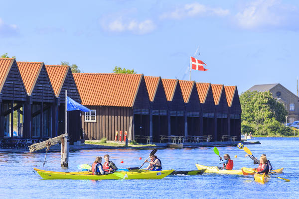 People on kayak seen from a boat trip along the canals of Copenhagen, Denmark
