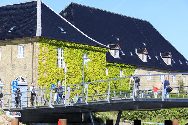 People and bicycles on typical bridge on the canal, Copenhagen, Denmark