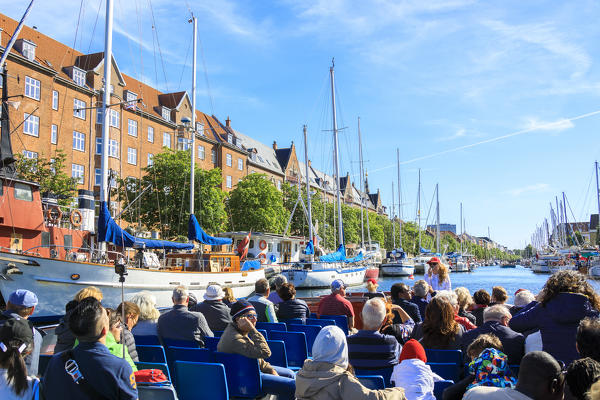 Tourists during a boat trip in the canals of Copenhagen, Denmark
